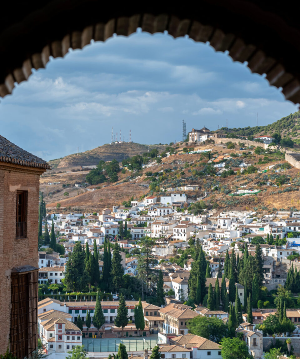 July 19, 2020:  Alhambra arch and Granada cityscape on the background. Granada, Spain
